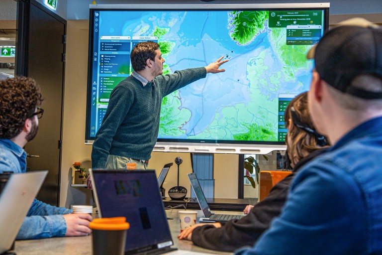 Een man geeft een presentatie voor een Digibord